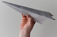 Hand holding a paper airplane