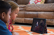 Two children watching conference on an iPad