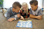 Three kids looking at the Friend