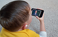 Boy watching conference on a phone