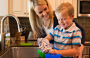 Mother and son cleaning dishes