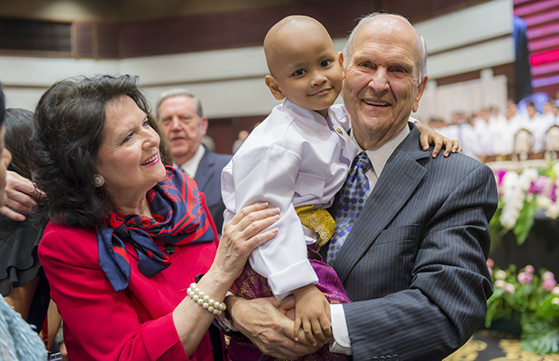 President Russell M. Nelson holds a child with his wife, Wendy, by his side in Bangkok, Thailand, Friday, April 20, 2018.