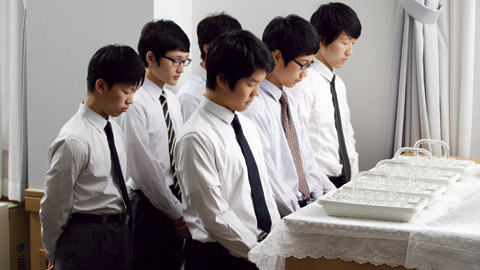 Young men serving the sacrament.