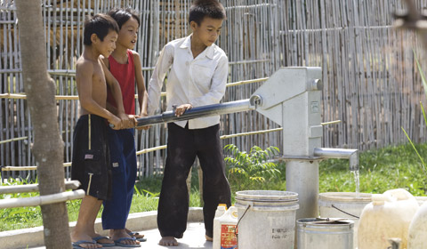 boys at a water pump