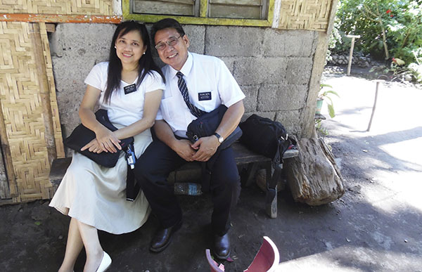 senior missionary couple with young women