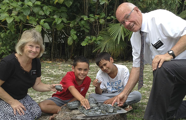 senior missionary couple with young women