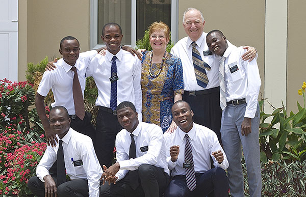 senior missionary couple with young women