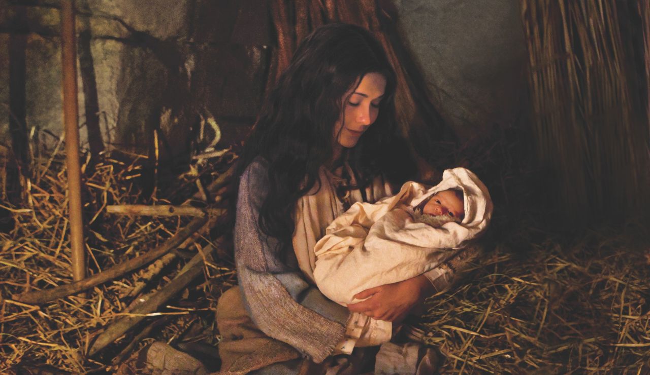 Mary holds the newborn Jesus Christ in the stable