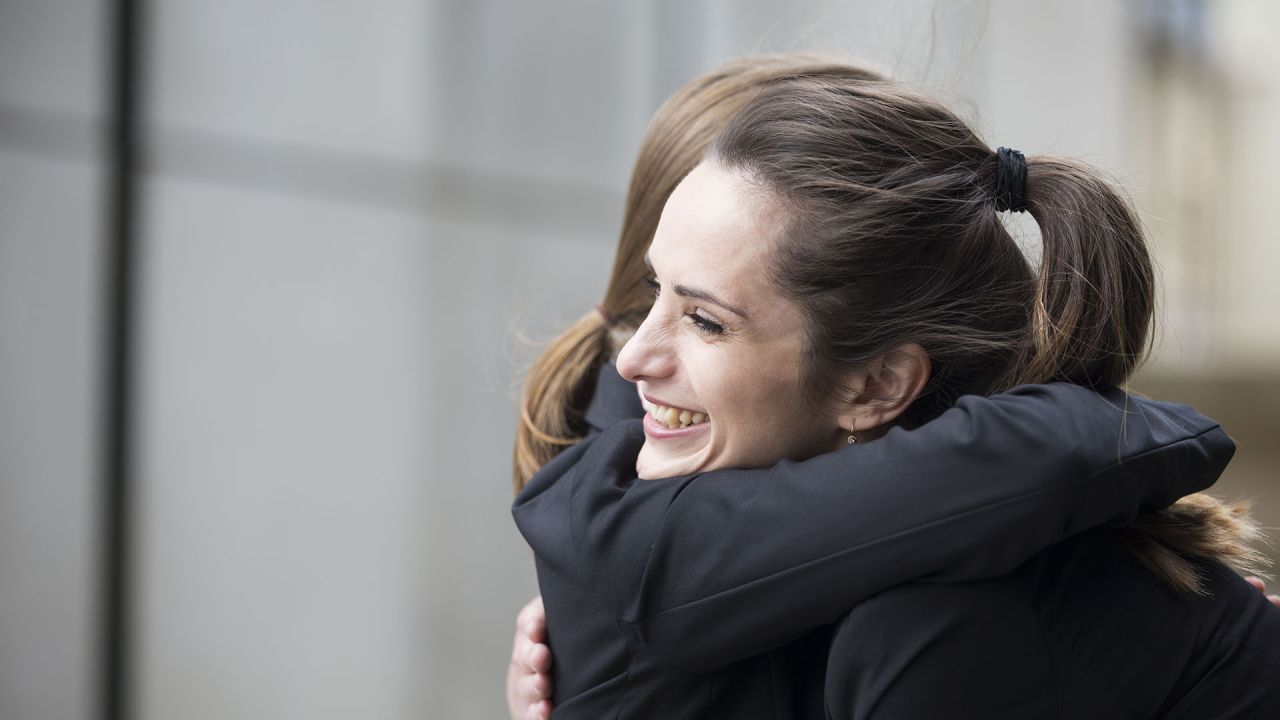 Two women hug and forgive each other
