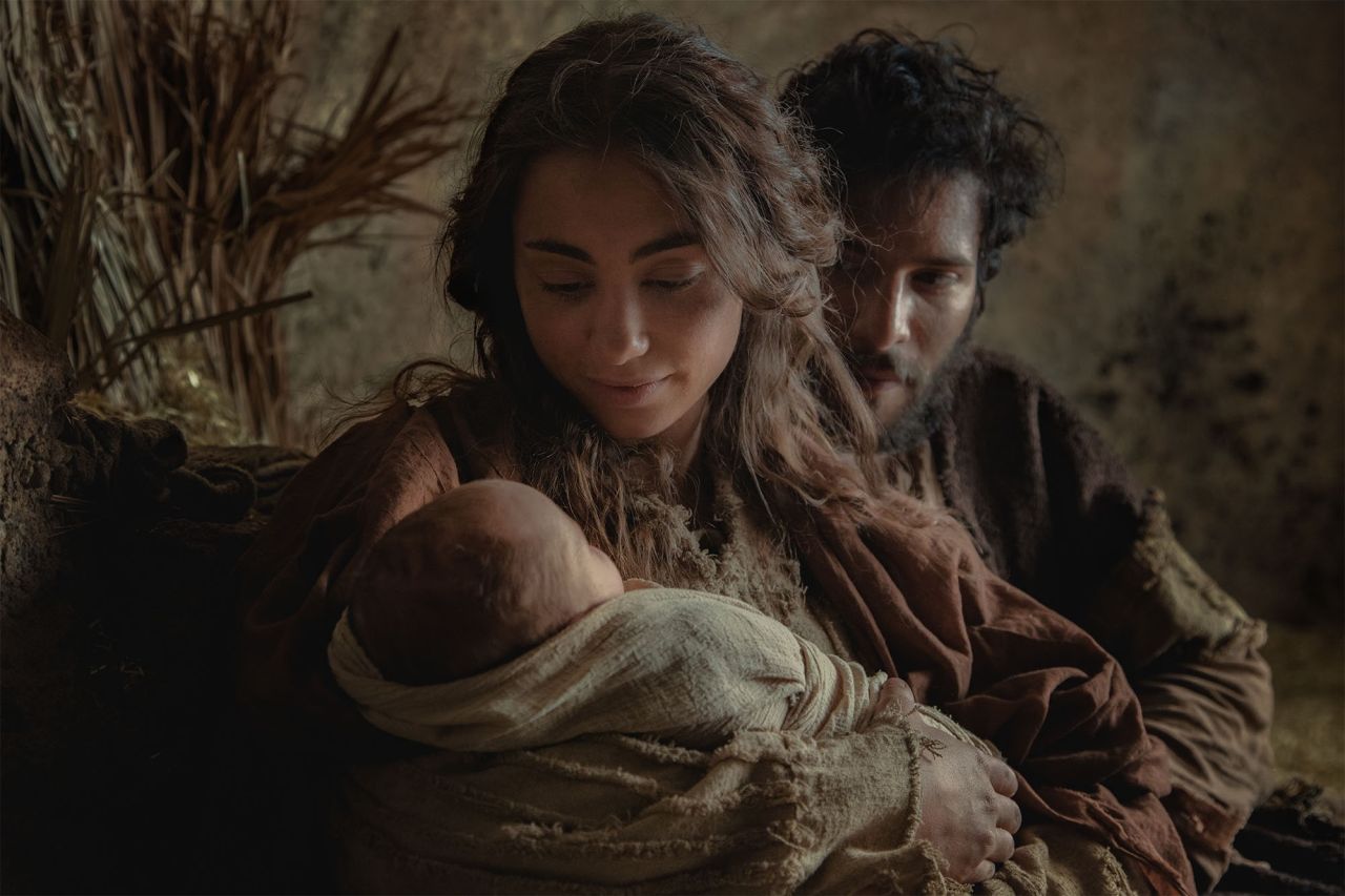 Mary and Joseph hold the baby Jesus