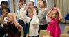 children doing motions while singing in church