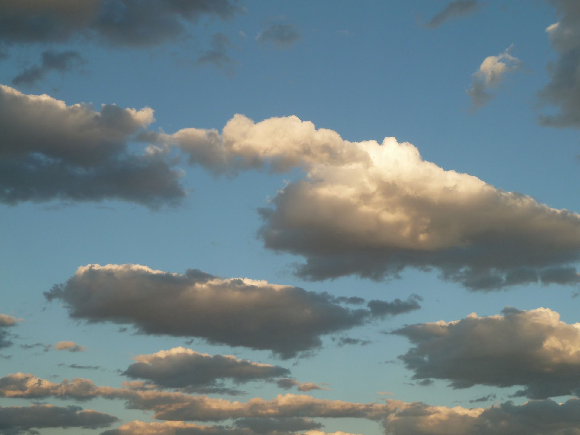 Small groups of clouds are spread out over the sky.