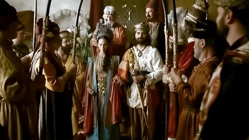 Queen Esther standing next to the king