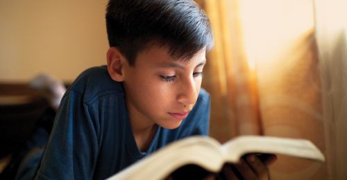 A Bolivian boy reading the scriptures.