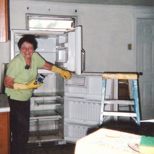 senior missionary cleaning a refrigerator