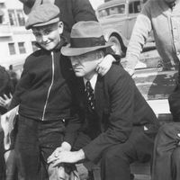 Thomas S. Monson as a boy standing with his arm around his father, G. Spencer Monson.  His grandfather, Thomas Sharp Condie is sitting next to them.  They are on vacation at Ocean Park, California.