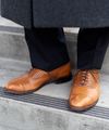 A senior missionary models appropriate dress and attire. He is wearing approved shoes.