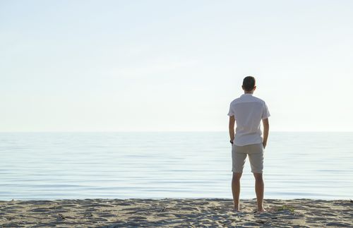 man looking out into the ocean