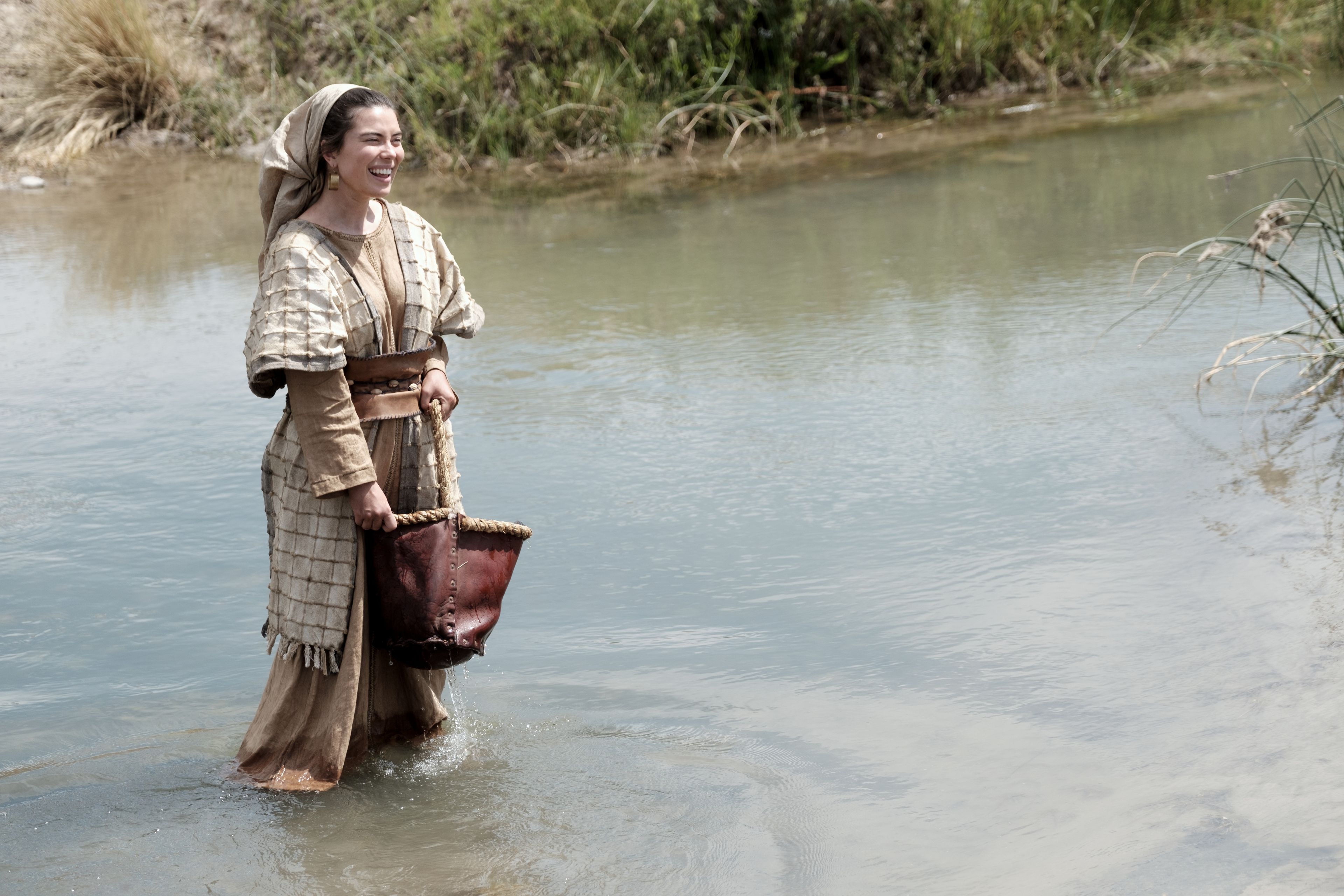 One of Ishmael's daughters gathers water from a stream in the wilderness.