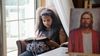 youth reading scriptures near a picture of the Savior