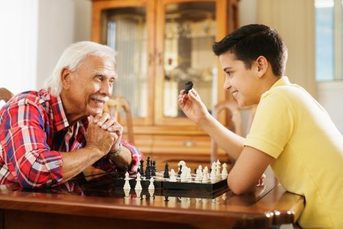 Grandfather and grandson playing chess