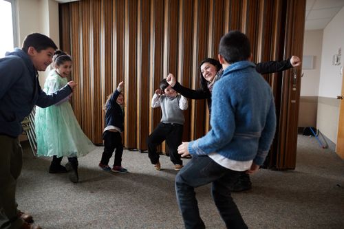A Primary teacher in Argentina dances with the children in her class.