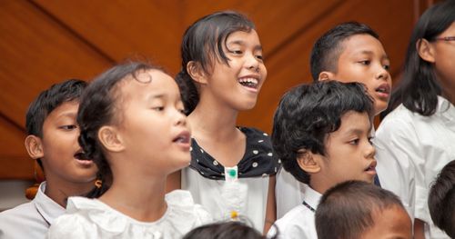 A photo of children singing in a Primary program.