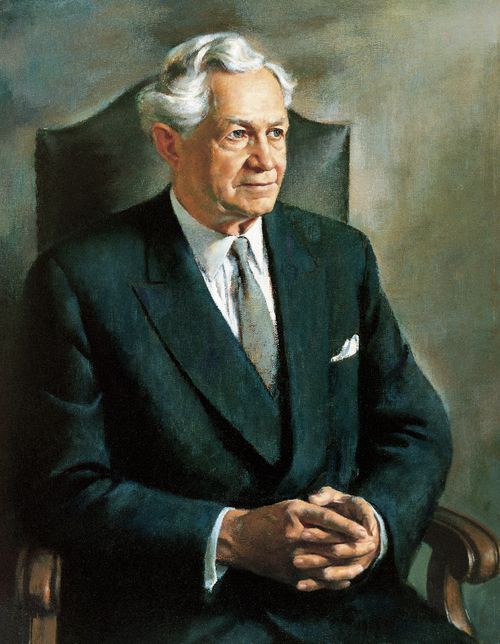 A painted portrait by Alvin Gittins of President David O. McKay in a black suit, sitting in a chair with his fingers clasped together.