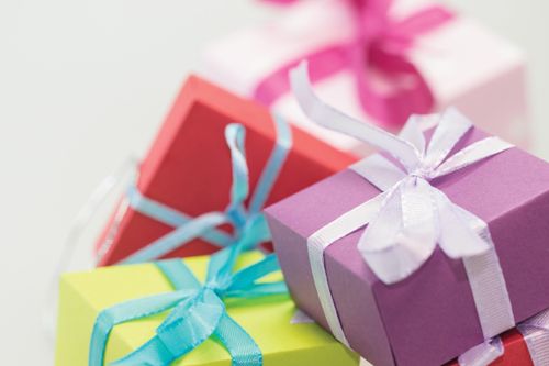 Several brightly colored small boxes wrapped with ribbons.