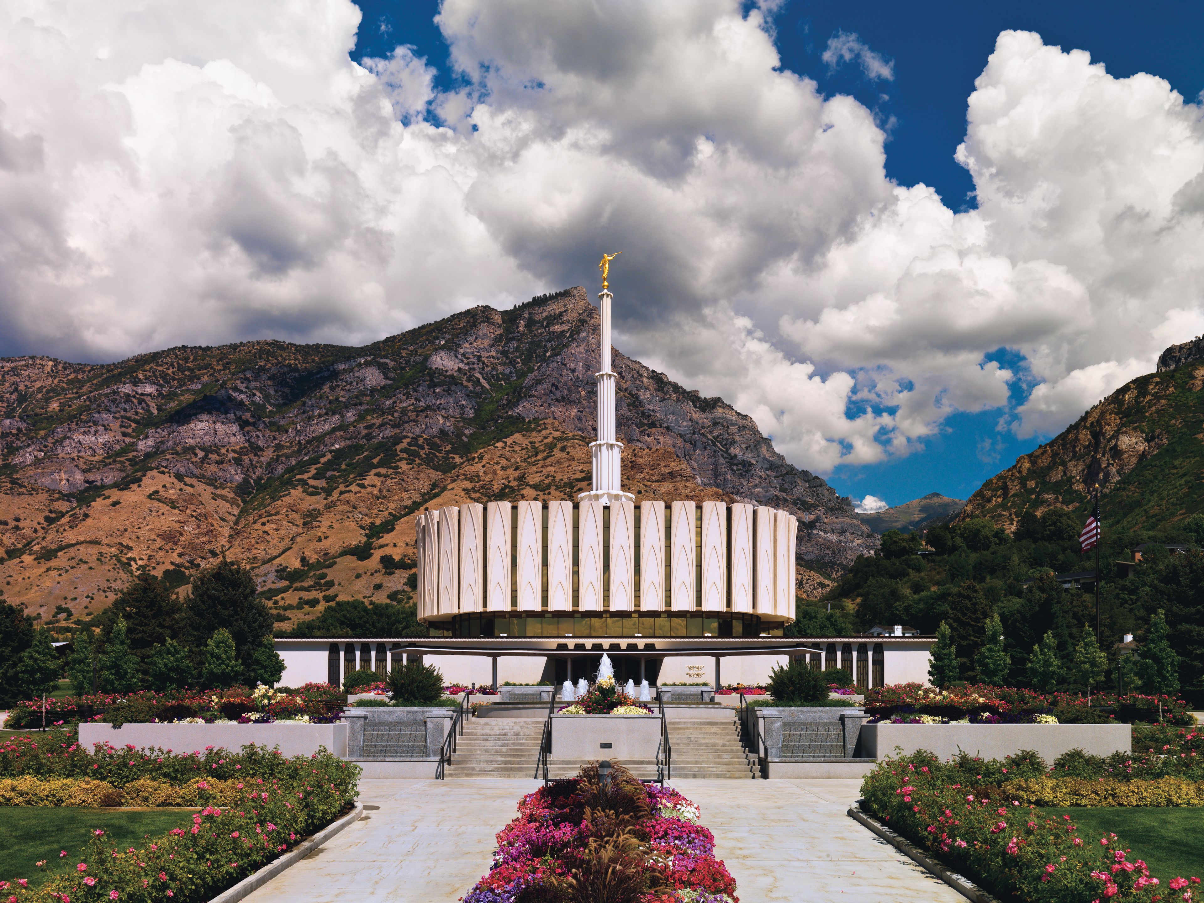 The front of the Provo Utah Temple on a partly cloudy day.
