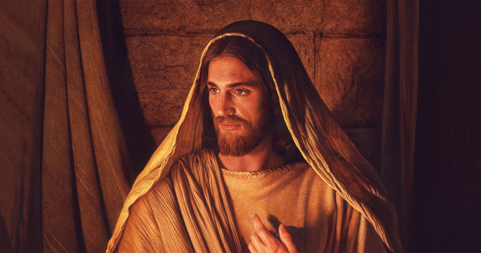 Jesus Christ points to Himself while seated in a warmly lit room.