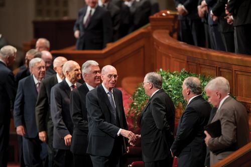 A photograph of members of the Quorum of the Twelve and First Presidency after a session of general conference.