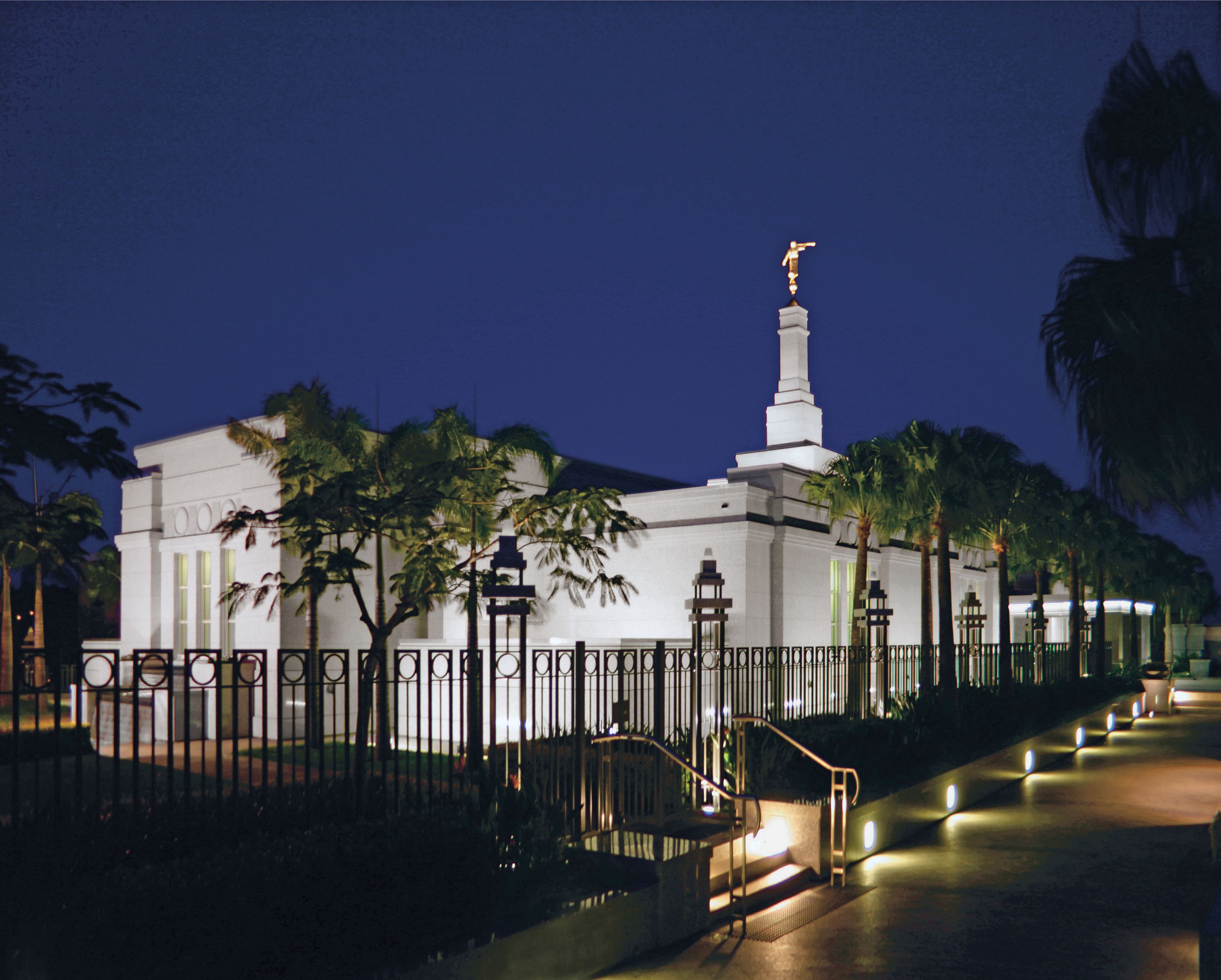 The Brisbane Australia Temple and grounds lit up at night.