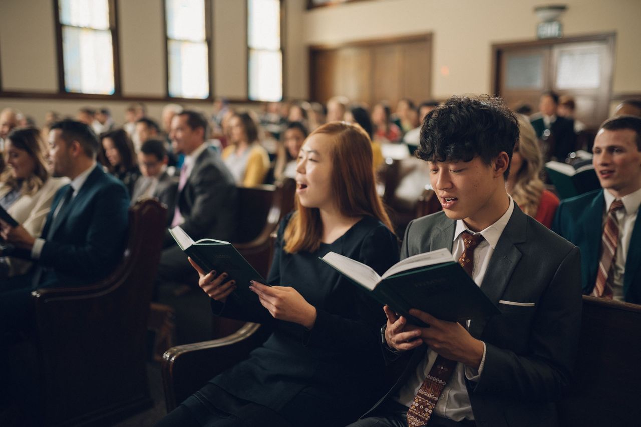 People sing hymns of worship at church