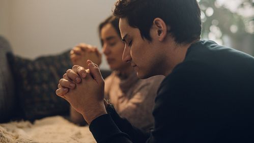 Two people praying together