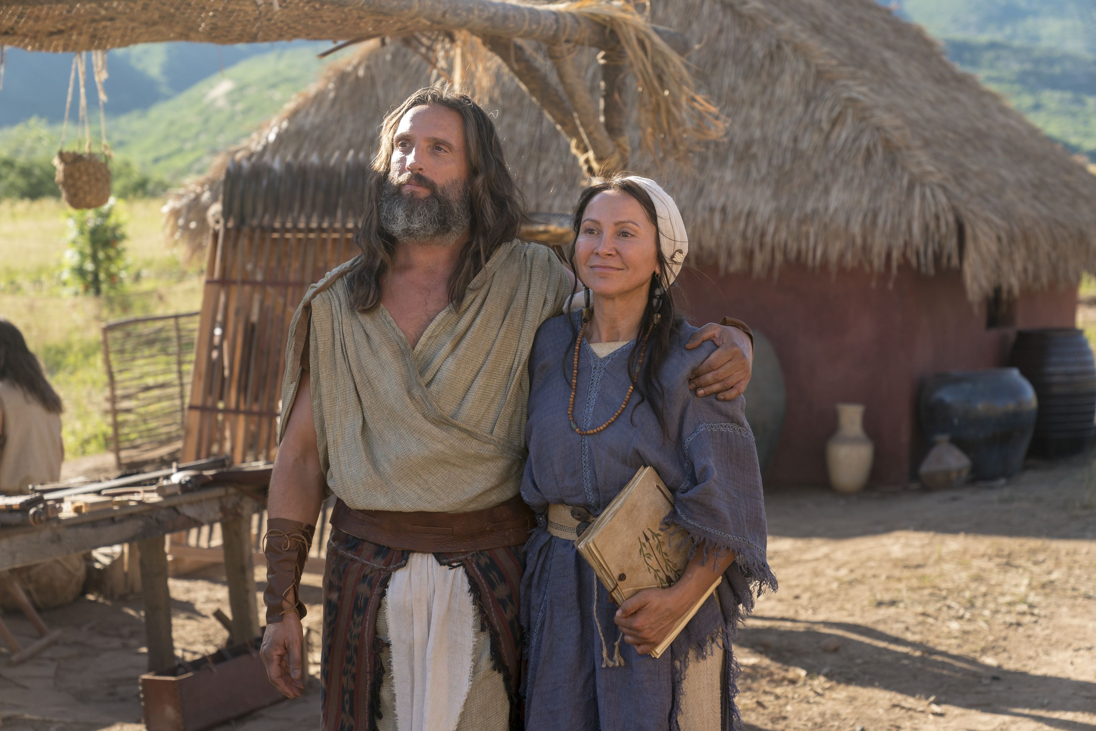 Nephi with his arm around his wife.