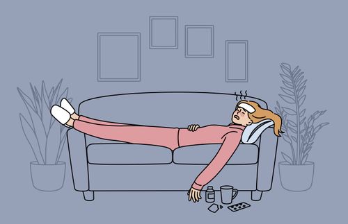 a woman lying on the couch and feeling sick