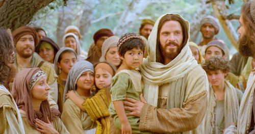 Jesus talks with the little children.