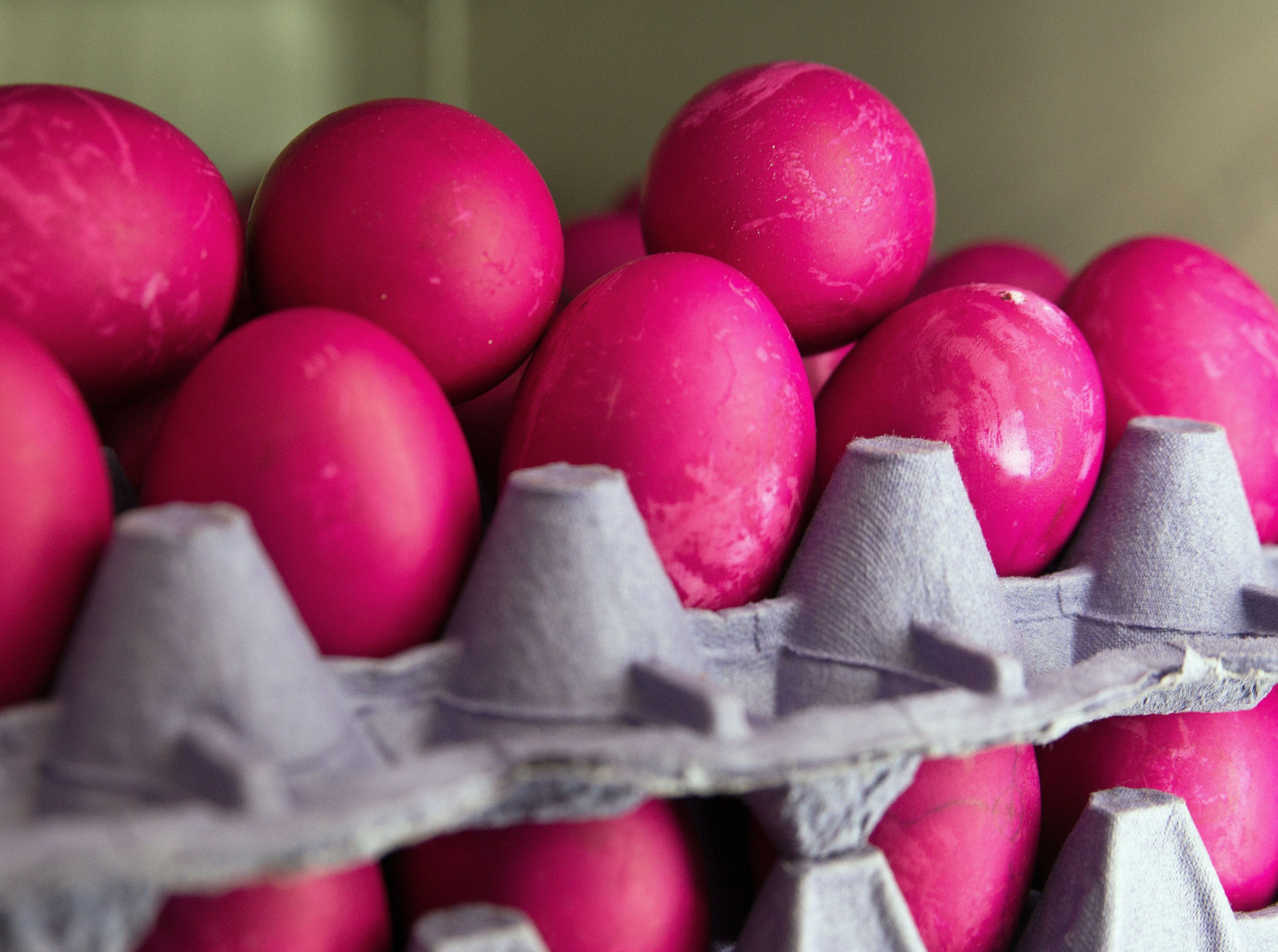 A stack of Easter eggs that have been dyed pink.
