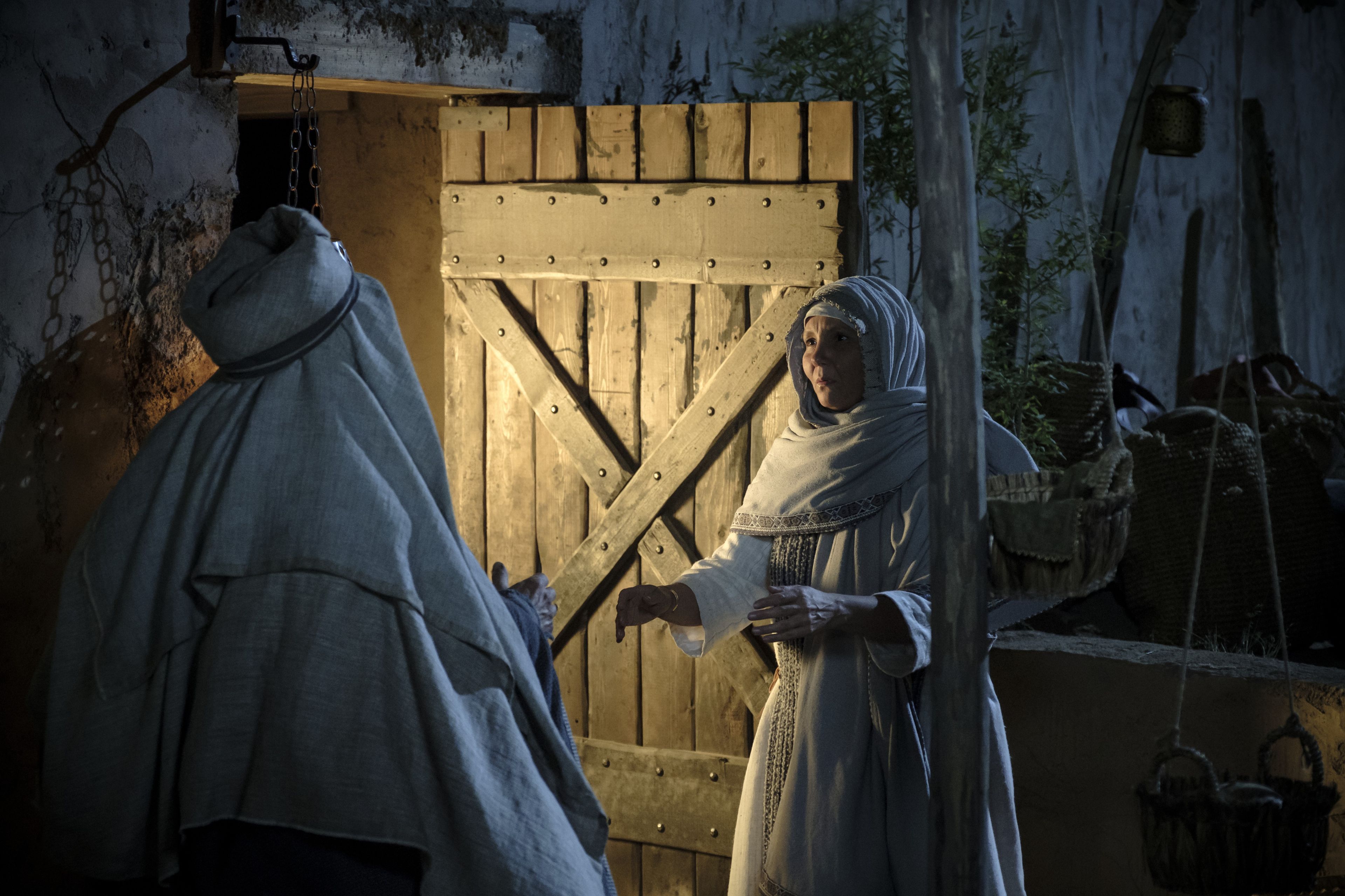 Sariah meets Lehi at the door of their home at Jerusalem.