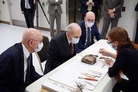 Church History curator employees show Russell M. Nelson, president of The Church of Jesus Christ of Latter-day Saints, with first counselor, President Dallin H. Oaks, and second counselor, President Henry B. Eyring the contents of the time capsule from the Salt Lake Temple.