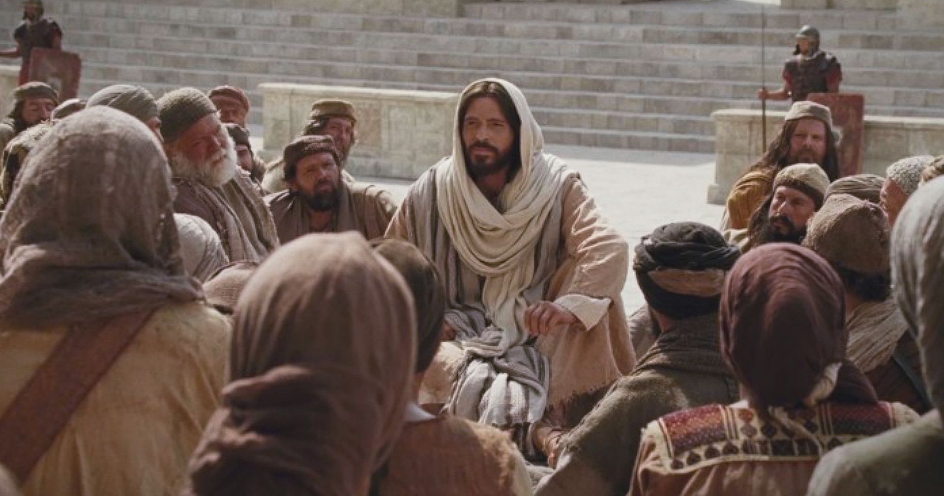 Jesus Christ sitting in a crowd as He reveals He is the Good Shepherd.