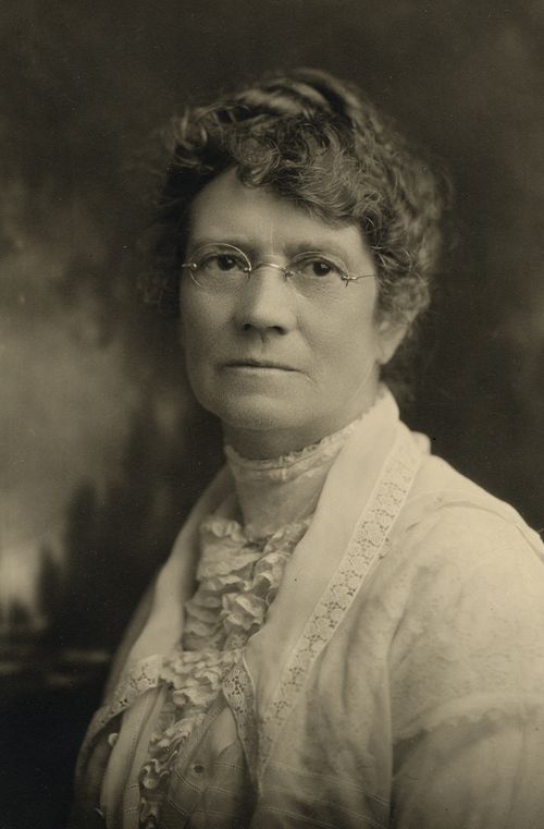 A black-and-white photograph of Ruth May Fox wearing a white dress and lace collar.