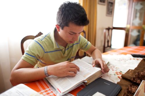 young man studying scriptures