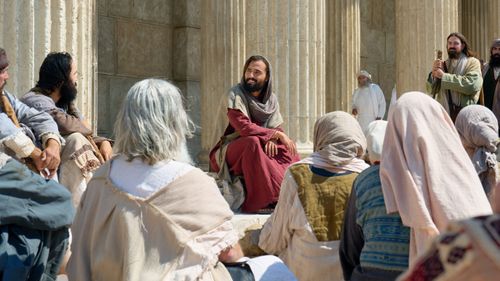 Jesus Christ teaches a small group of people in Jerusalem. An angel shows this experience to Nephi after he inquires about Lehi's vision.