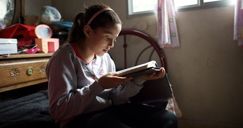 Young female child studying scriptures in Uruguay.