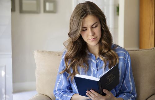 young woman reading Book of Mormon