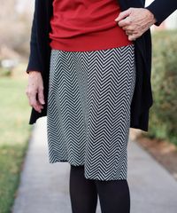 A senior missionary models appropriate dress and attire. She is wearing an approved sweater, blouse and skirt.