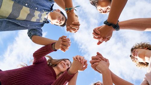 youth holding hands in a circle