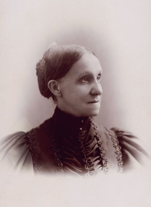 A photograph of Elmina Shepard Taylor wearing a high-collared black dress. The image is in black and white.